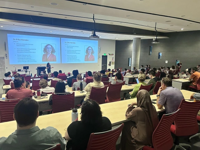 photo of large lecture hall filled with audience members listening to speaker Erika Hamden at TIMESTEP's internship symposium in September 2025