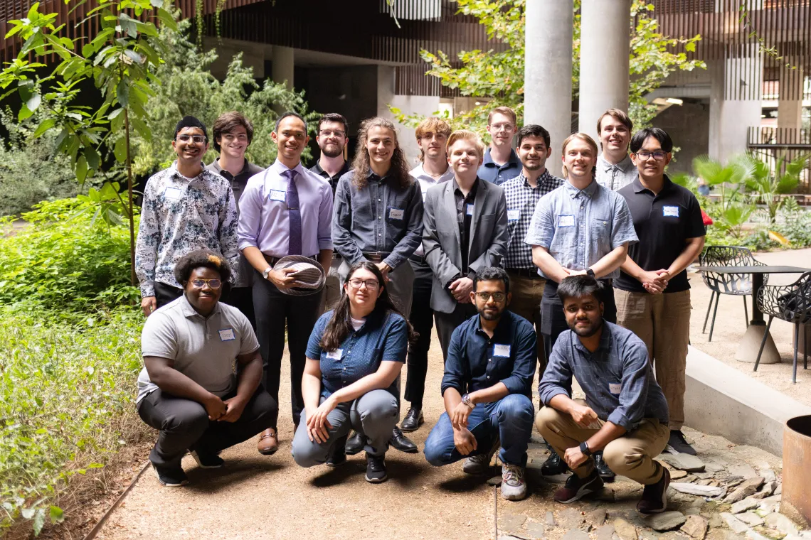 Group of 16 UA undergrads standing together posed for the picture